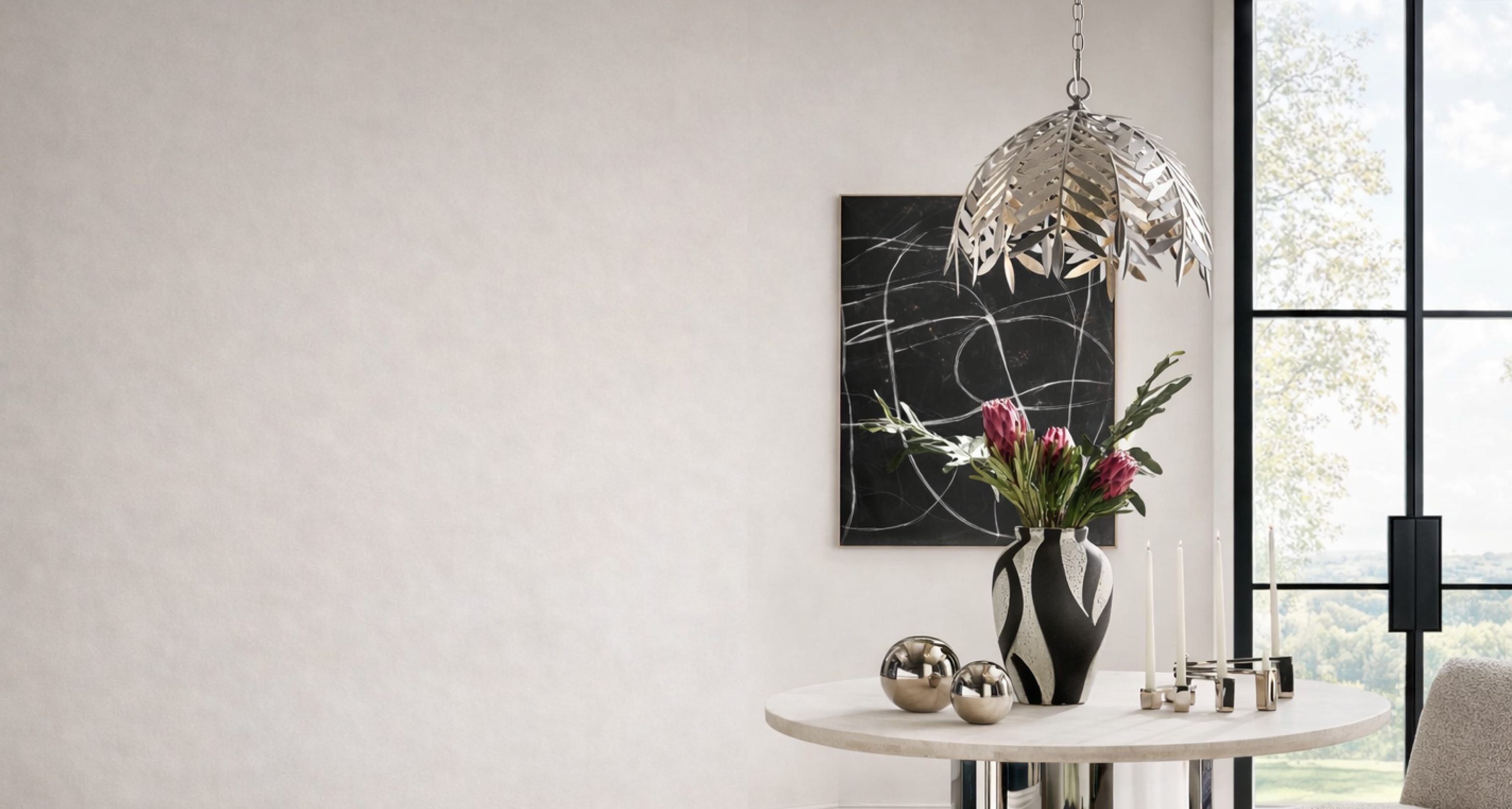 Sculptural polished nickel leafy cut-out dome pendant light suspended above a modern dining table styled with a zebra pattern vase.