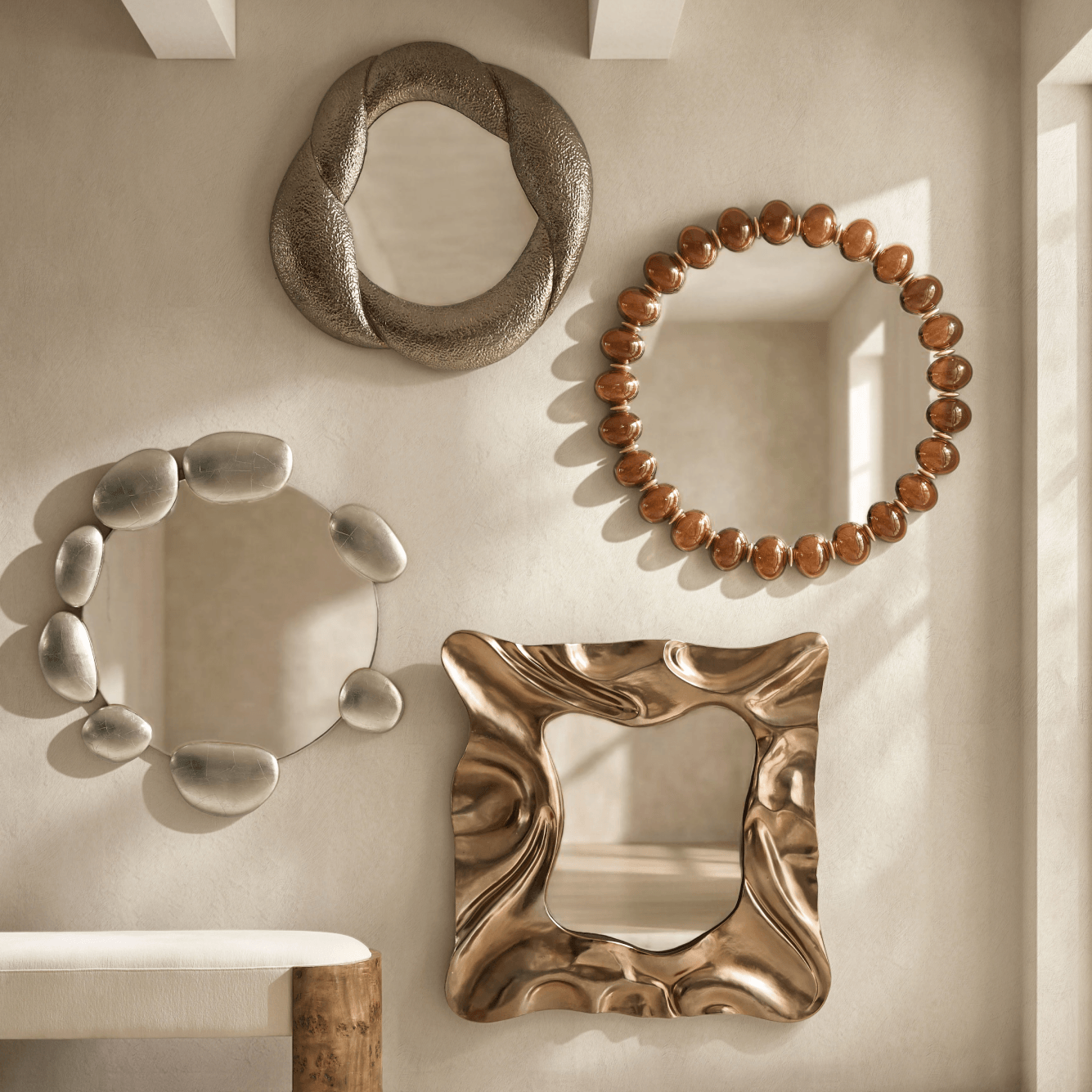 Gallery wall display of decorative mirrors including organic wavy shapes, beaded frames, and sculpted metallic borders.