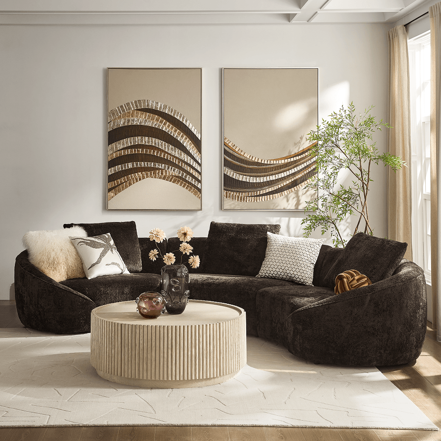 Dark brown curved sectional sofa paired with white organic coffee tables in a modern living room setting.