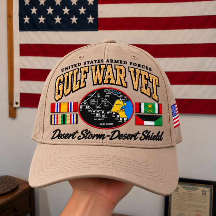 Khaki Gulf War Veteran tribute cap displayed before an American flag