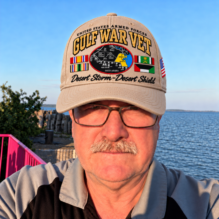 Mature man wearing the Gulf War Veteran tribute cap near the water