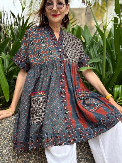 Loose fitting indigo blue and red cotton tunic is from artisan made Ajrakh fabric. Colorful Kutch hand embroidery highlights the pockets