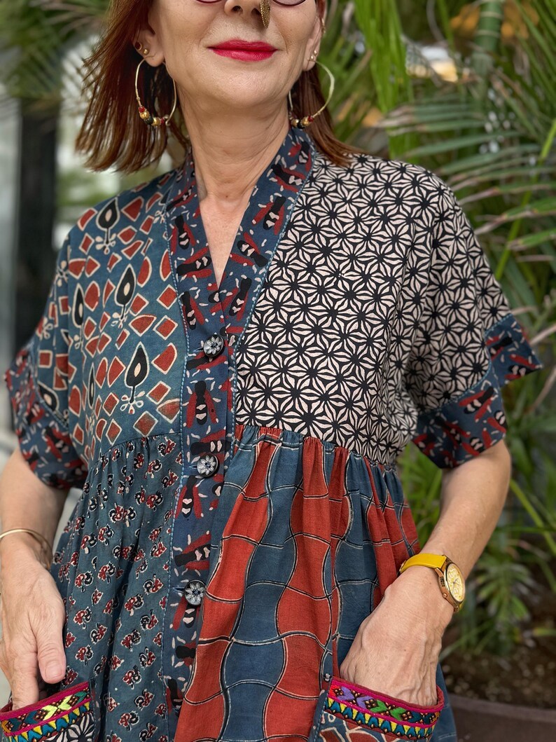 Loose fitting indigo blue and red cotton tunic is from artisan made Ajrakh fabric. Colorful Kutch hand embroidery highlights the pockets
