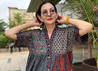Loose fitting indigo blue and red cotton tunic is from artisan made Ajrakh fabric. Colorful Kutch hand embroidery highlights the pockets