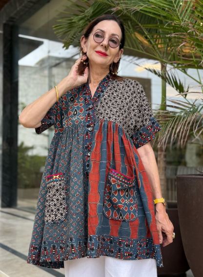 Loose fitting indigo blue and red cotton tunic is from artisan made Ajrakh fabric. Colorful Kutch hand embroidery highlights the pockets