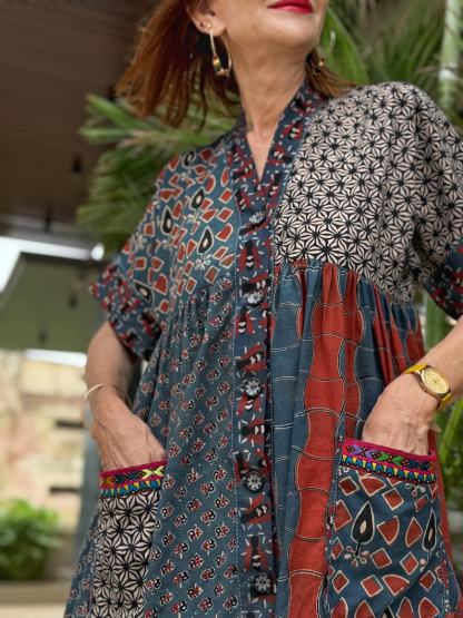 Loose fitting indigo blue and red cotton tunic is from artisan made Ajrakh fabric. Colorful Kutch hand embroidery highlights the pockets