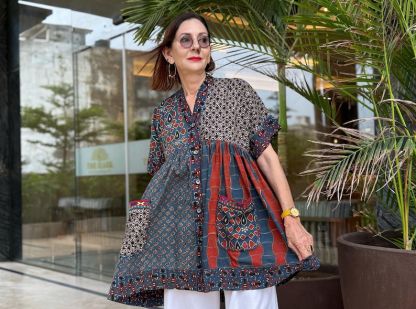 Loose fitting indigo blue and red cotton tunic is from artisan made Ajrakh fabric. Colorful Kutch hand embroidery highlights the pockets