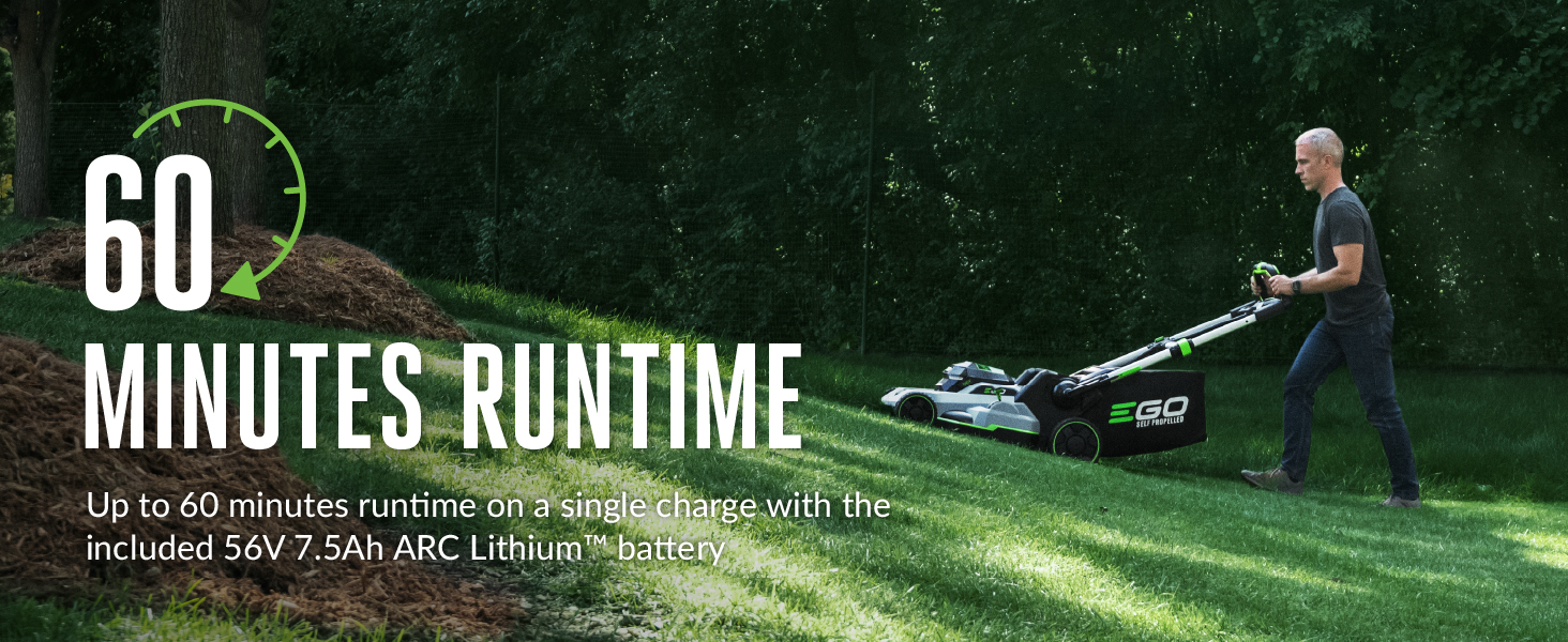 man pushing mower up a hill on partially cut yard to show 60 minute run time of mower