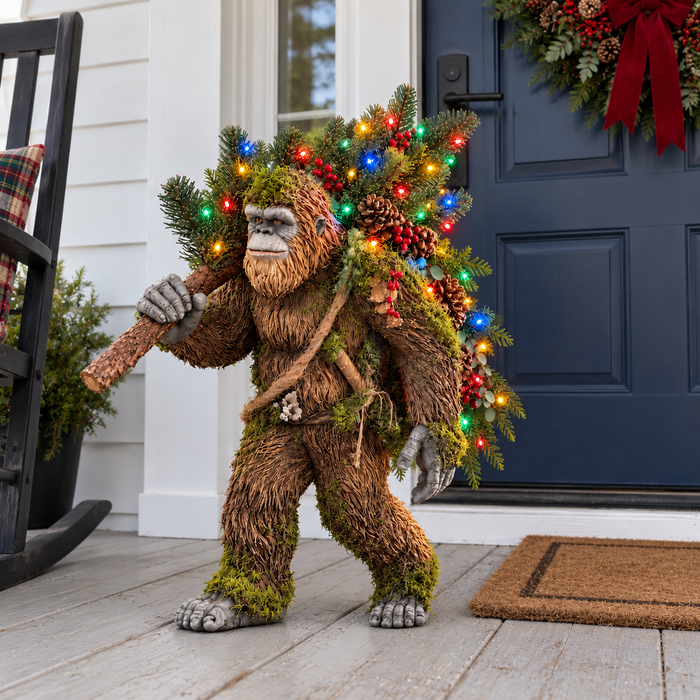 Sasquatch beside a blue door on a wooden porch
