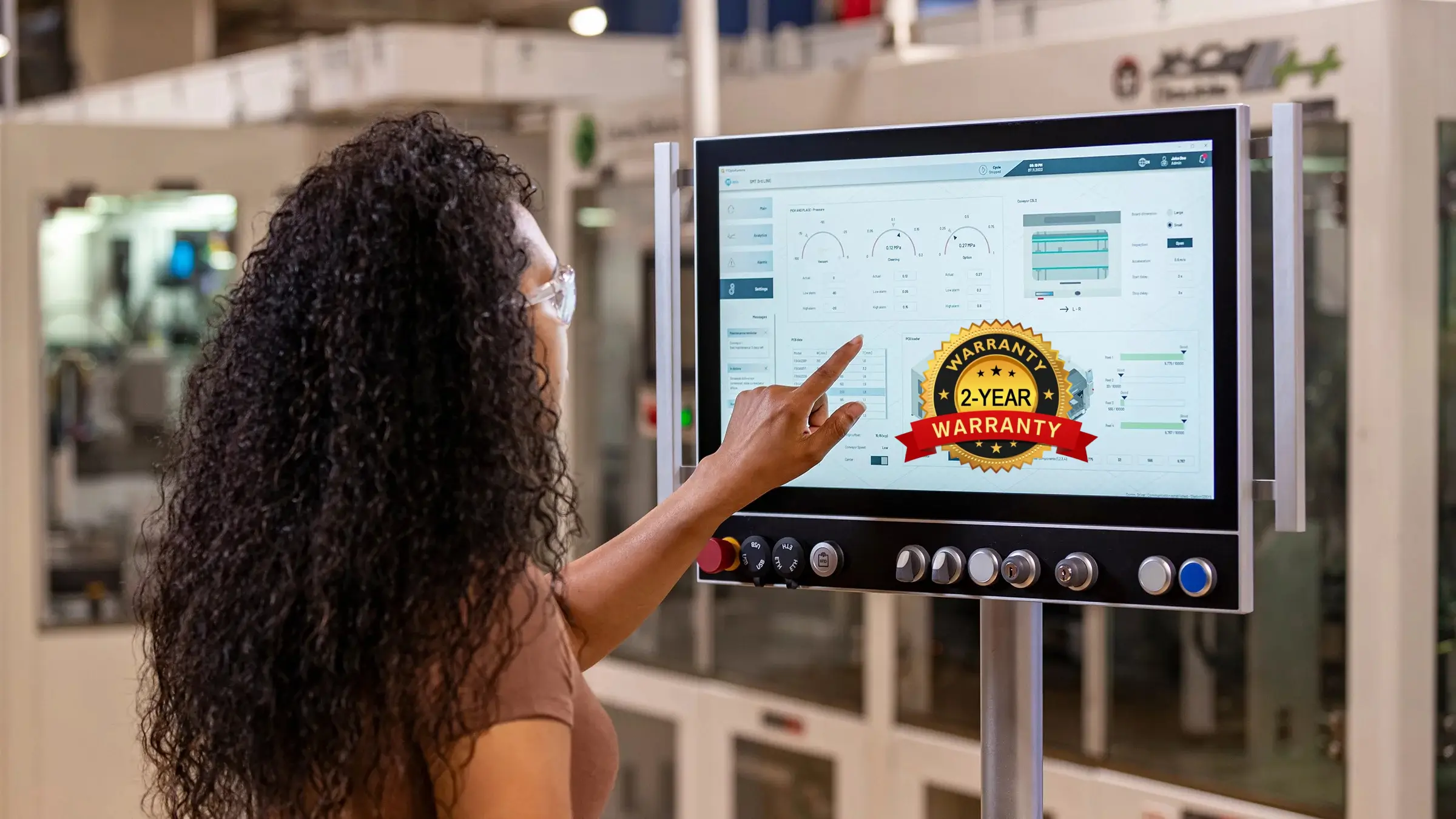 {"default":"Female operator interacting with automation dashboard on touchscreen monitor"}
