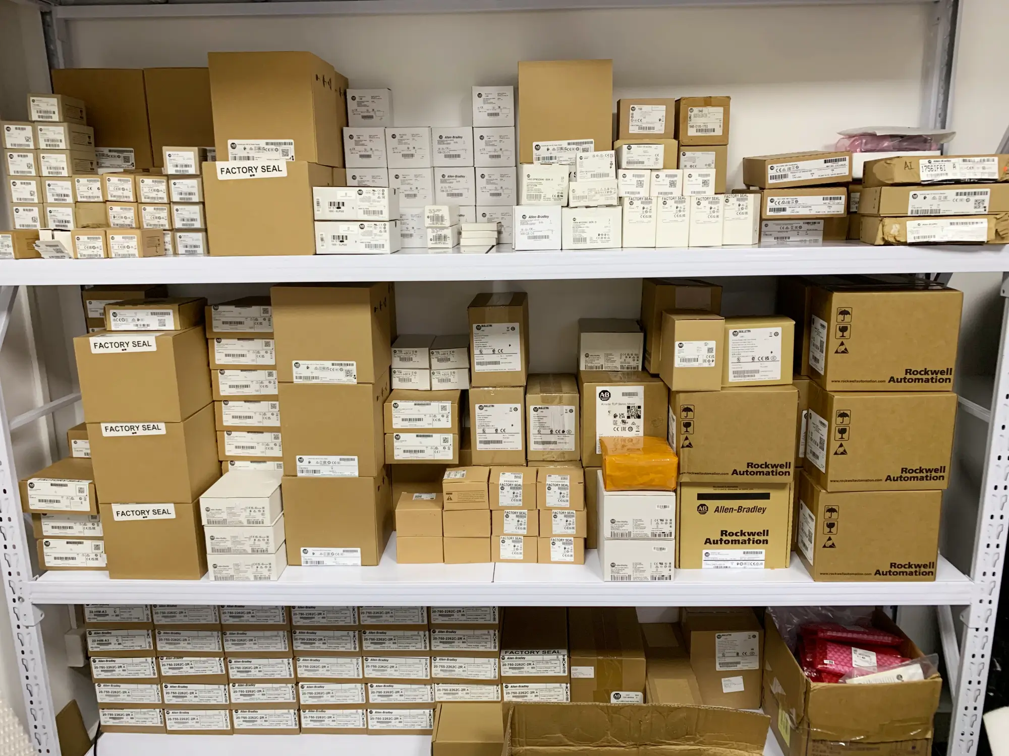 {"default":"Factory-sealed Allen-Bradley PLC boxes ready for DHL Express global delivery."}
