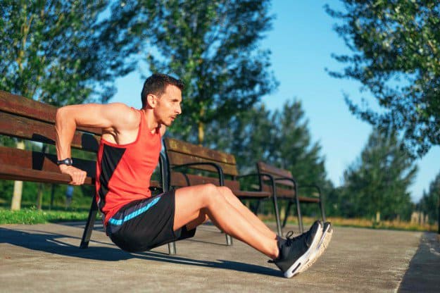 Fitness-man-doing-bench-triceps-dips-bodyweight-exercises-gt