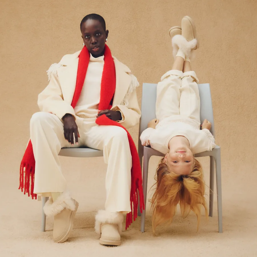 The UGG Classic Ultra Mini Chalet A feminine person and a kid wearing matching, cozy fits and matching Classic Ultra Mini Chalet boots.