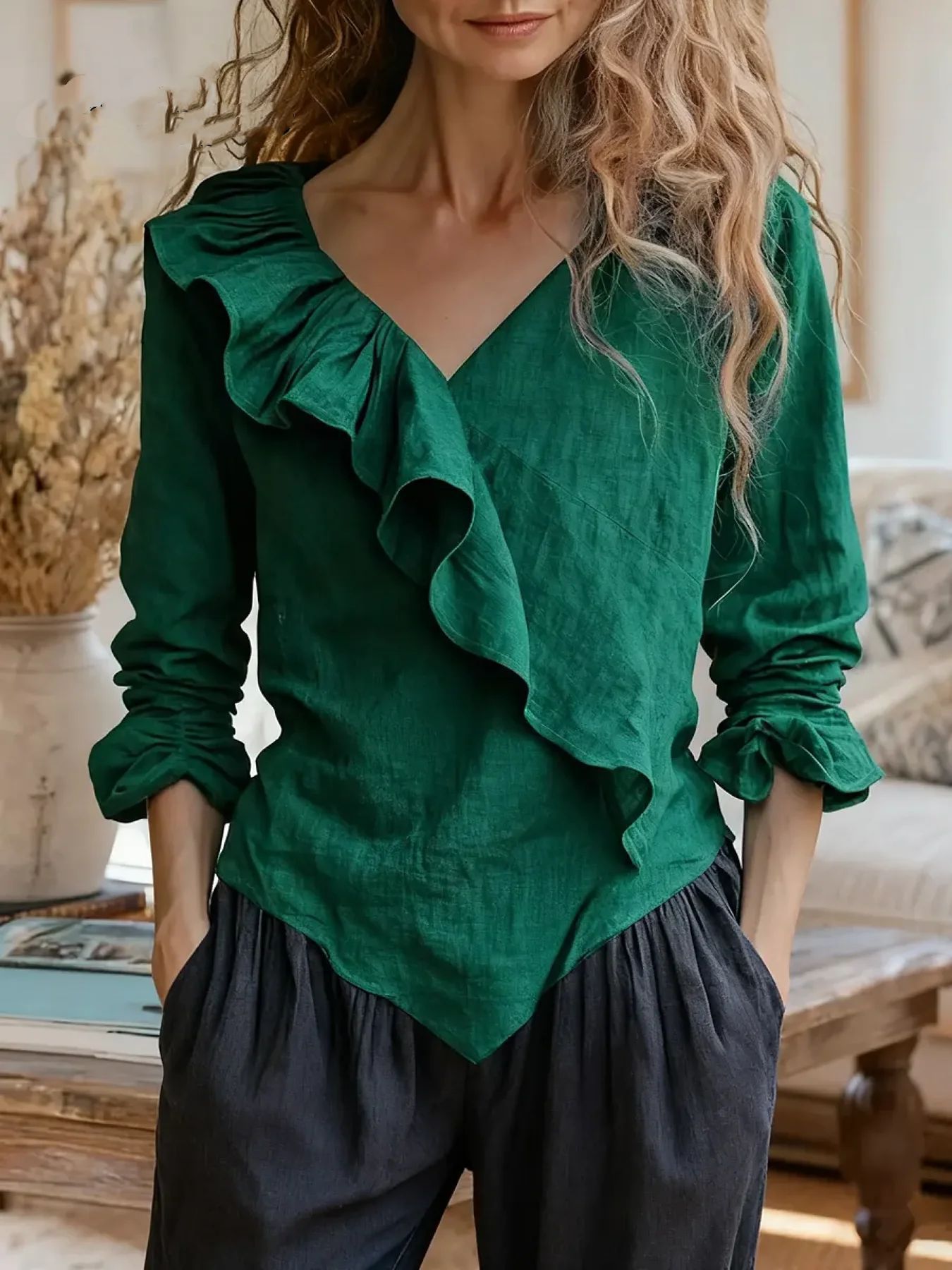Women's solid color cotton and linen top with ruffle trim.