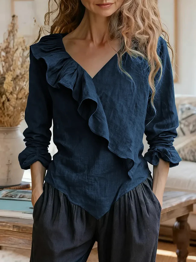 Women's solid color cotton and linen top with ruffle trim.