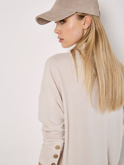 A soft-milky white, tubular-shaped mini knitted dress