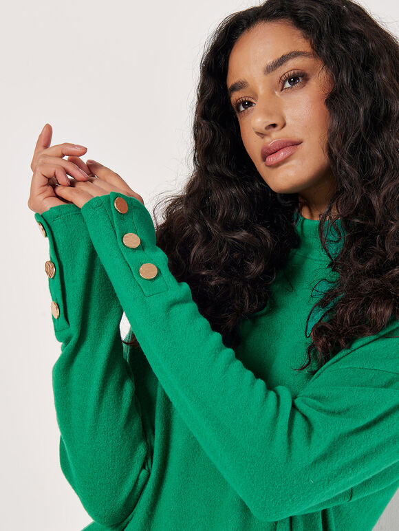 A soft green-textured, pod-shaped mini knitted dress