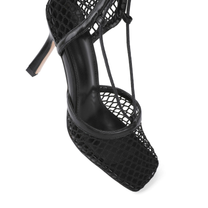 Close-up of stiletto heel and wrap-around lace-up straps
