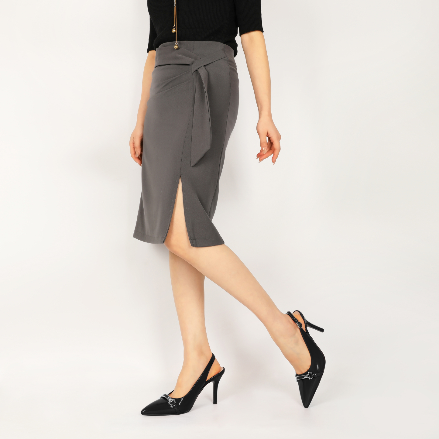 Close-up of a model wearing black SAMMITOP slingback heels with pointed toe and stiletto heel