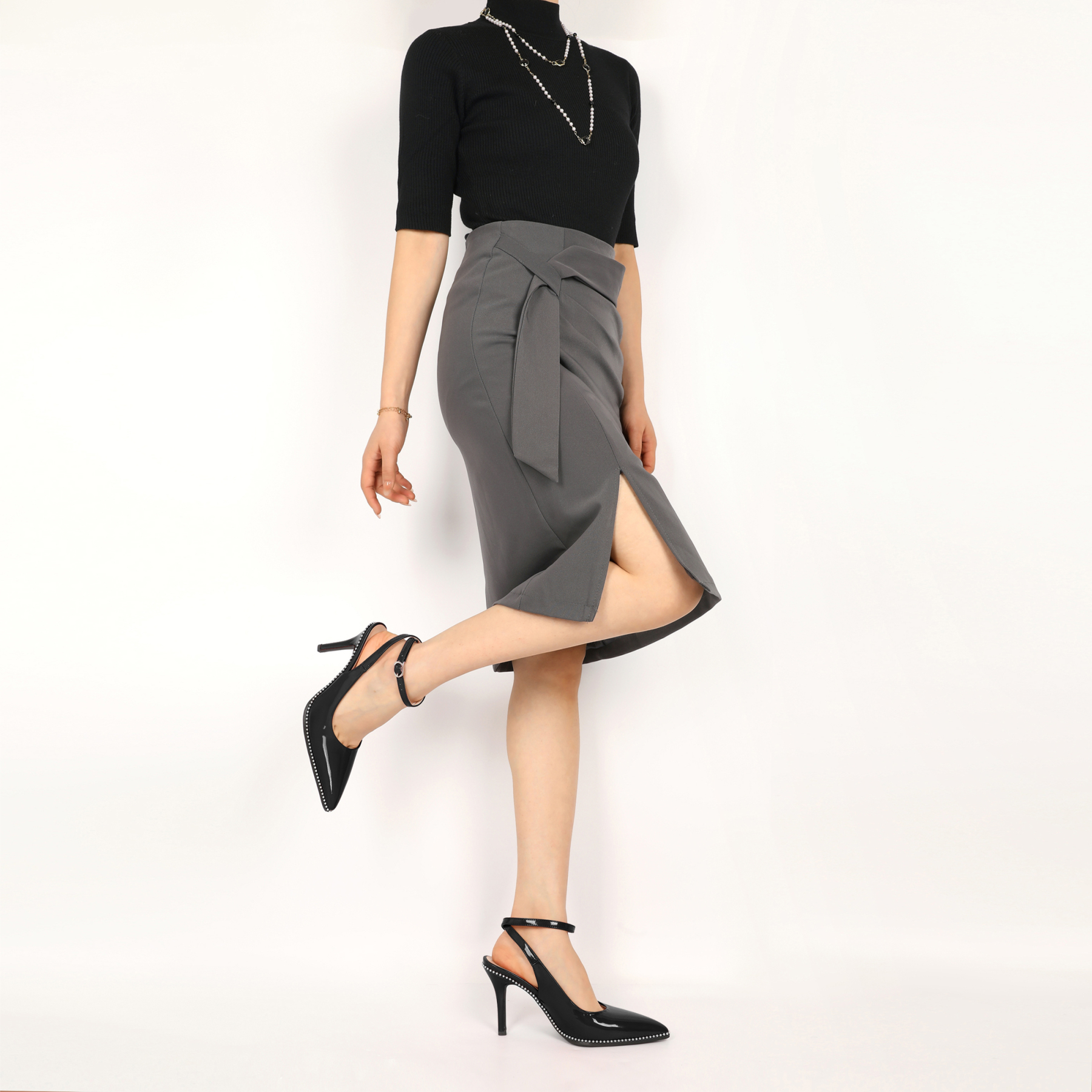 Front view of slingback pumps with ankle strap worn by model