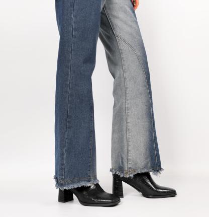 Model wearing black croc embossed ankle boots with jeans
