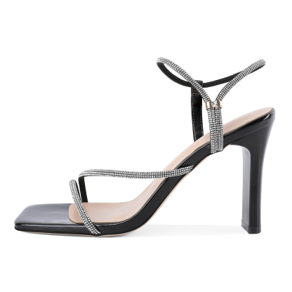 Side view of black chunky heels showing ankle strap and heel height