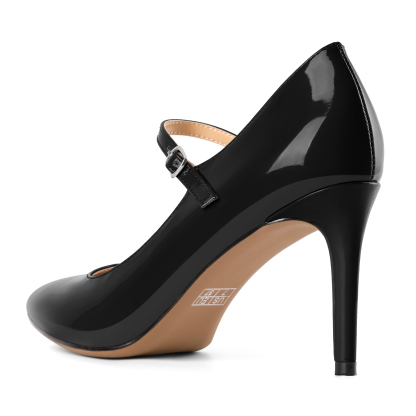 Back angle displaying heel construction and stability on beige pumps