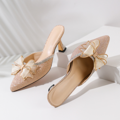 Gold stiletto low heels close-up of rhinestone ankle strap

