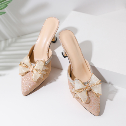 Gold stiletto low heels close-up of rhinestone ankle strap

