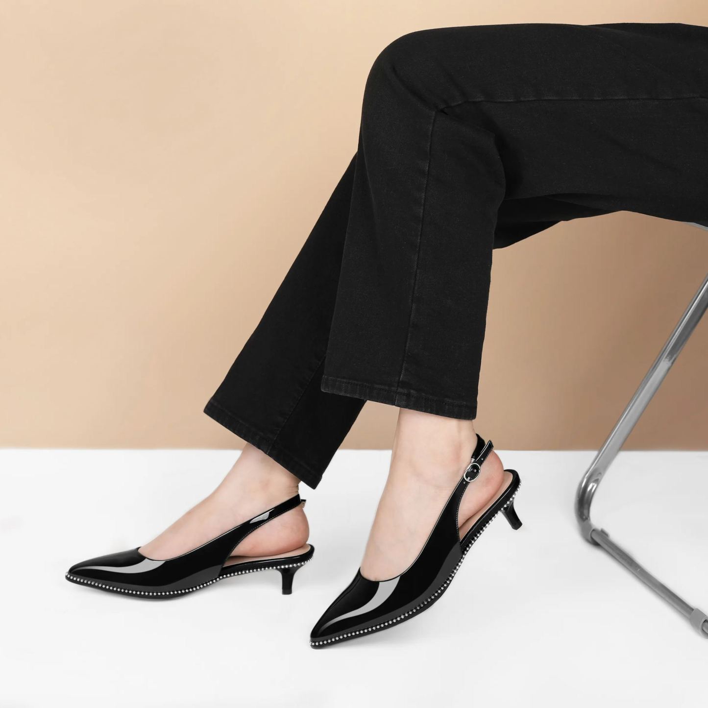 Beige beaded kitten pumps styled with tailored trousers for office chic