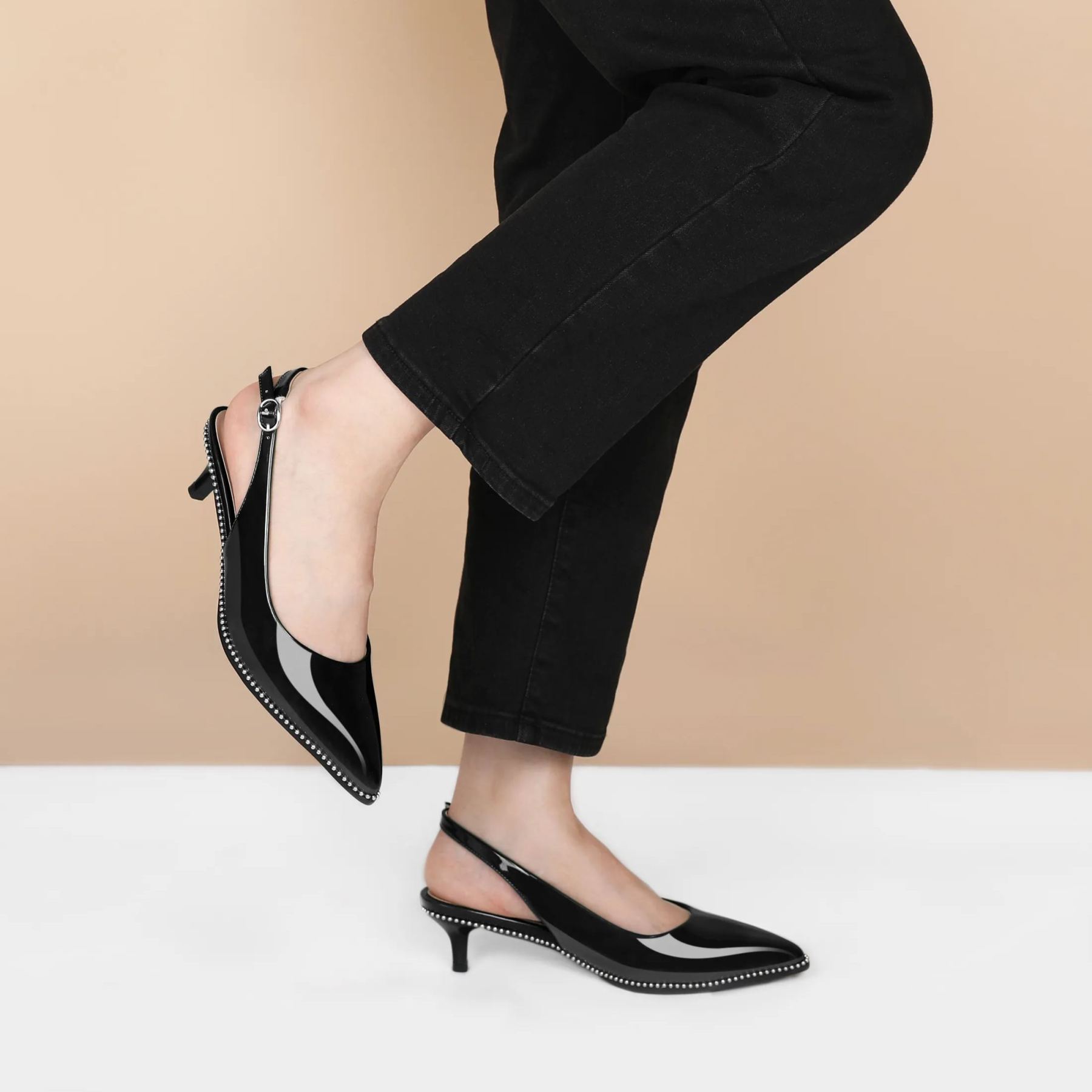 Beige beaded kitten pumps styled with tailored trousers for office chic