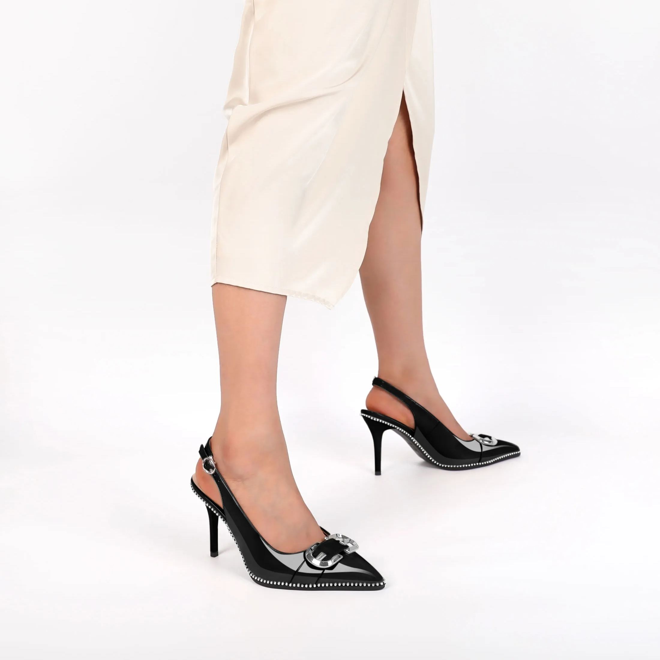 Woman styling beige slingback stilettos with tailored pants for office chic

