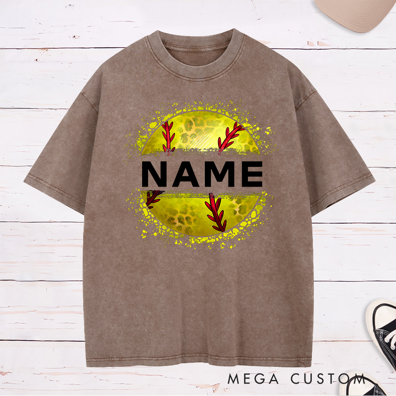 Personalized Softball Washed T-Shirt Design Featuring Custom Name Displayed Boldly Across a Distressed Softball Graphic with Textured Details