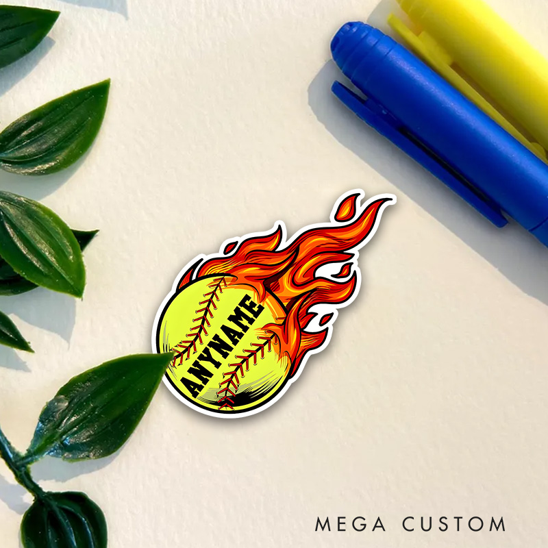 Personalized Softball Decal with Custom Name on a Vibrant Flaming Yellow Softball Design Featuring Bold Black Lettering Red Stitching and Dynamic Fire Effects