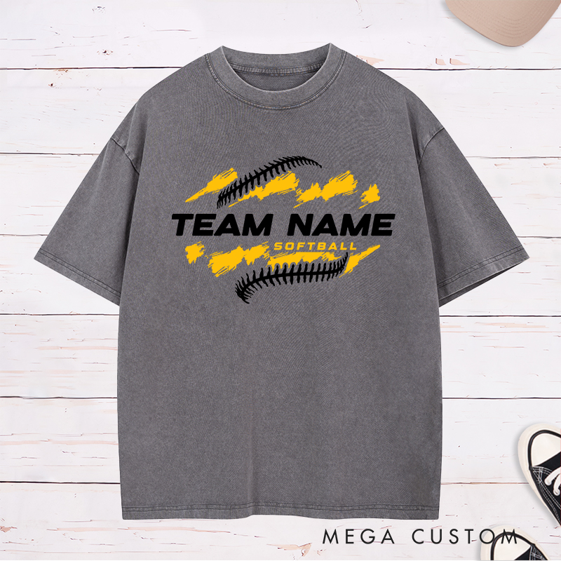 Personalized Softball Team Washed T-Shirt Design Featuring Customizable Team Name Bold Text Dynamic Brushstroke Elements and Softball Stitch Graphics