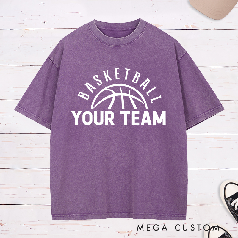 Personalized Washed T-Shirt Design Featuring a Clean Basketball Graphic with a Customizable Team Name Below an Arched Basketball Text