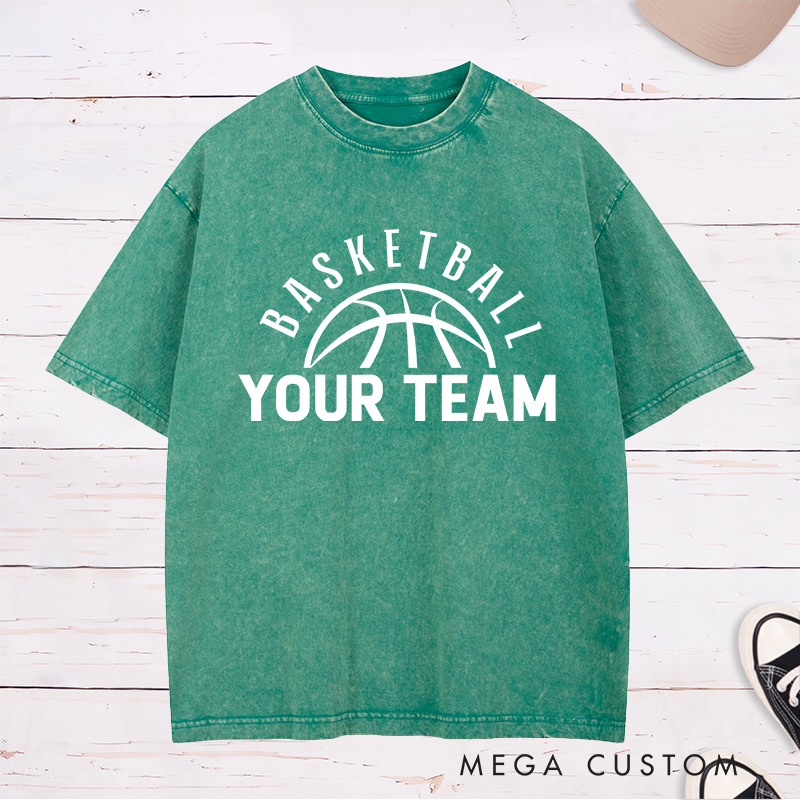 Personalized Washed T-Shirt Design Featuring a Clean Basketball Graphic with a Customizable Team Name Below an Arched Basketball Text
