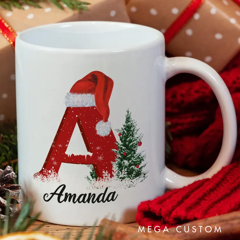 Personalized Christmas Initial Mug with Santa Hat and Tree Design for a Festive and Custom Holiday Gift Mug