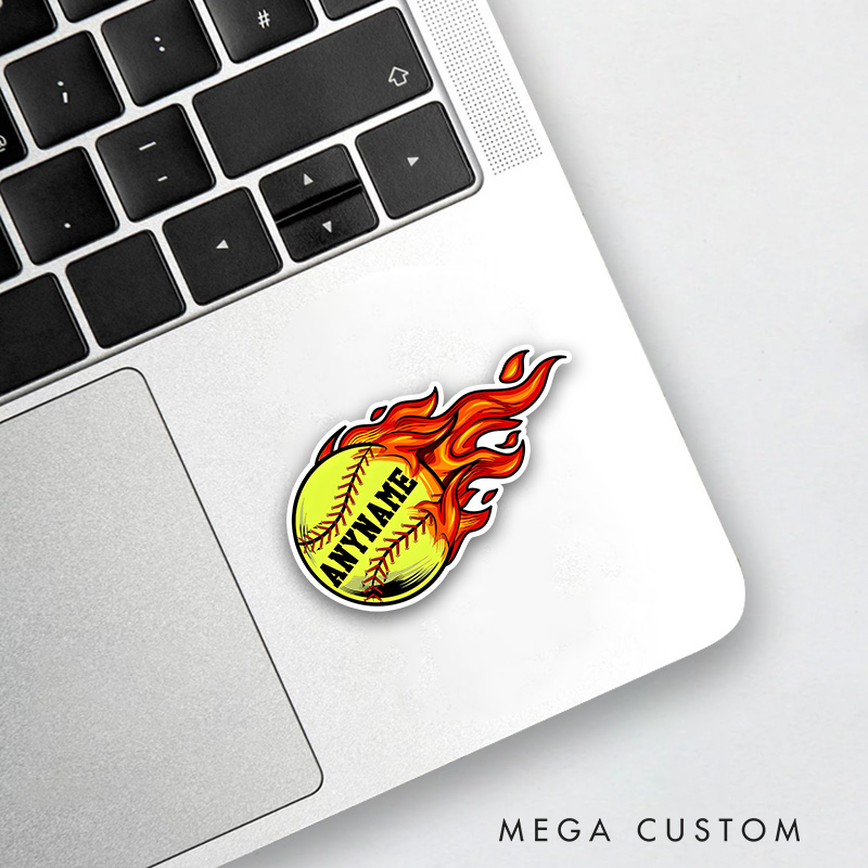 Personalized Softball Decal with Custom Name on a Vibrant Flaming Yellow Softball Design Featuring Bold Black Lettering Red Stitching and Dynamic Fire Effects