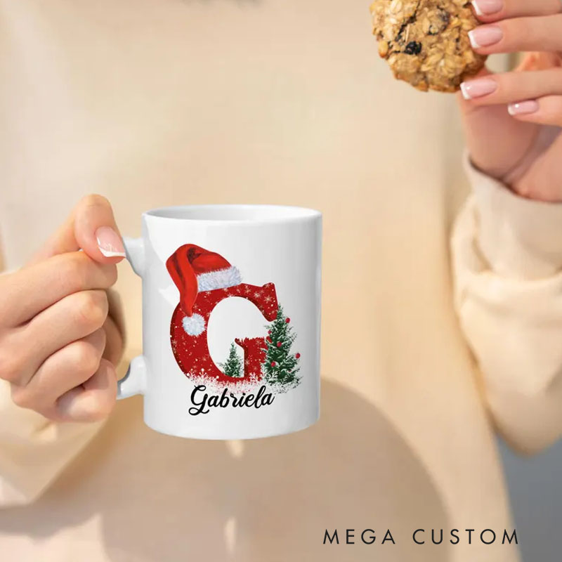 Personalized Christmas Initial Mug with Santa Hat and Tree Design for a Festive and Custom Holiday Gift Mug