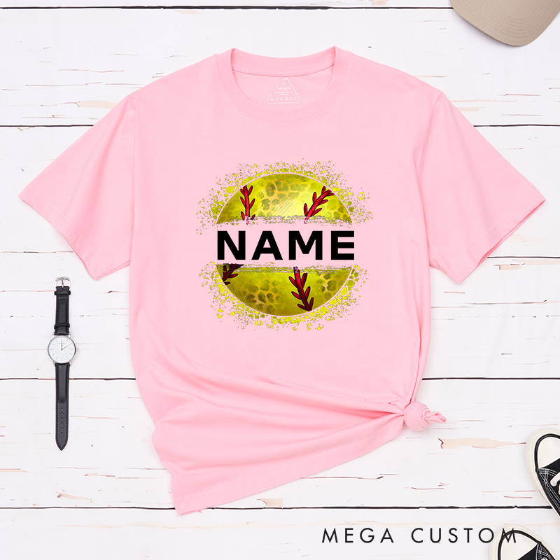 Personalized Softball T-Shirt Design Featuring Custom Name Displayed Boldly Across a Distressed Softball Graphic with Textured Details