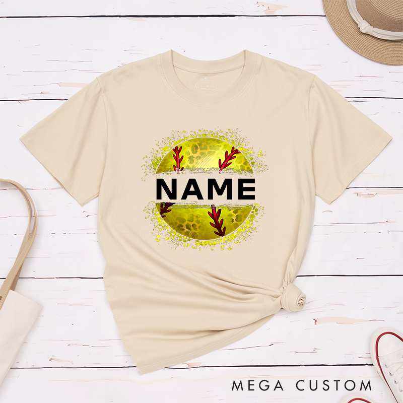 Personalized Softball T-Shirt Design Featuring Custom Name Displayed Boldly Across a Distressed Softball Graphic with Textured Details