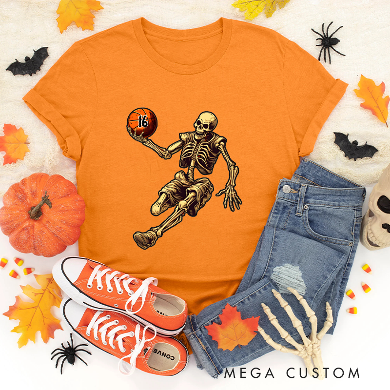 Personalized Halloween Basketball T-Shirt with Skeleton Dribbling Pumpkin Ball and Customizable Number Design
