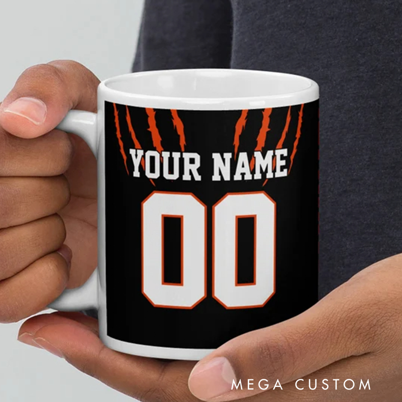 Personalized Football Mug with Customizable Team Name Player Name and Jersey Number in Bold Black and Orange Claw Design