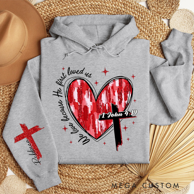 Personalized We Love Because He First Loved Us Classic Hoodies with Custom Name Heart Cross Valentine Bible Verse Hoodie Love Jesus Valentine Day Gift