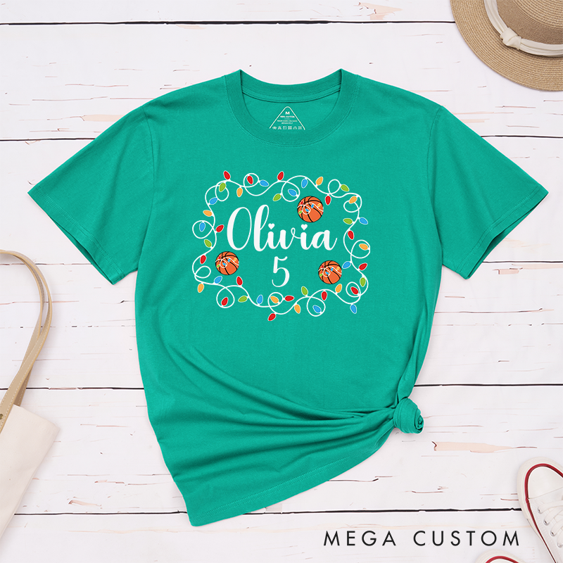 Personalized Christmas T-Shirt with Custom Name, Number, Basketballs, and Festive String Lights Design