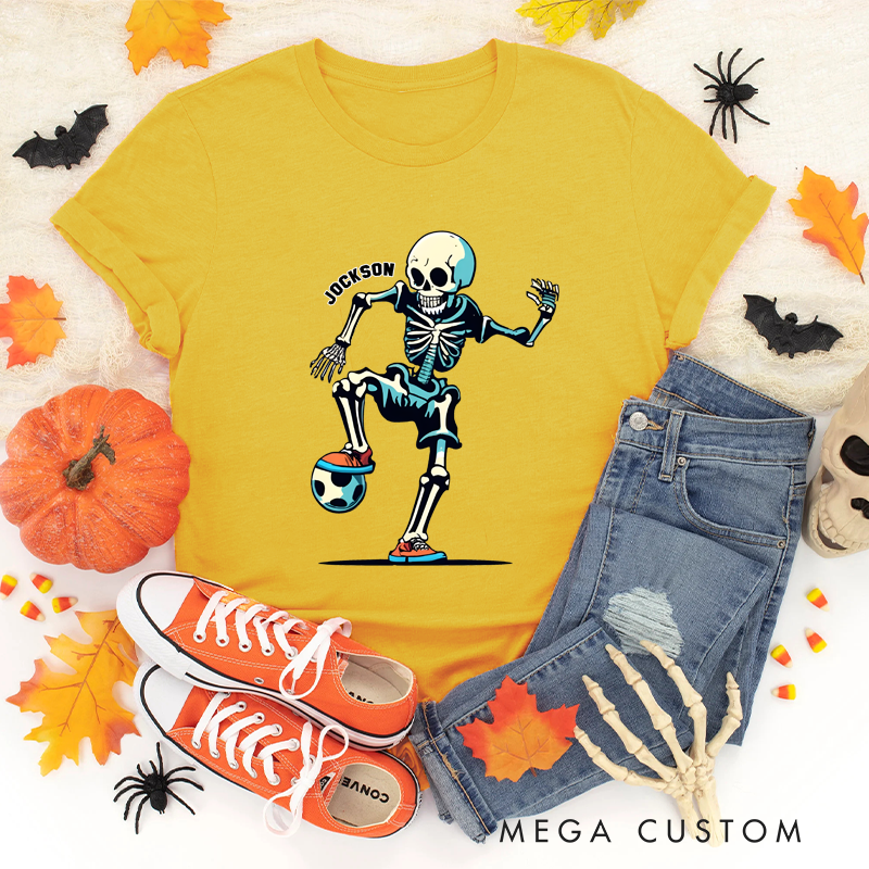 Personalized Halloween Soccer T-Shirt with Skeleton Kicking a Ball and Custom Name Design