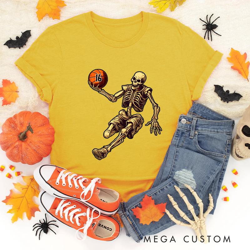 Personalized Halloween Basketball T-Shirt with Skeleton Dribbling Pumpkin Ball and Customizable Number Design