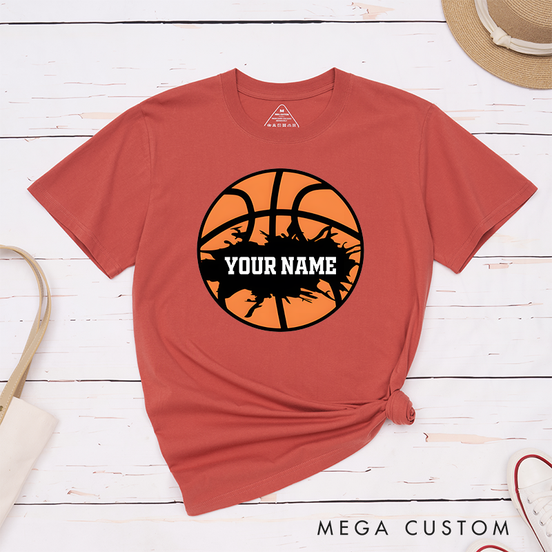Personalized Basketball T-Shirt Design Featuring Bold Orange Basketball Graphic with Splatter Effect and Customizable Name