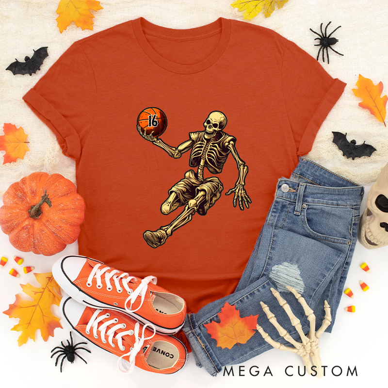 Personalized Halloween Basketball T-Shirt with Skeleton Dribbling Pumpkin Ball and Customizable Number Design